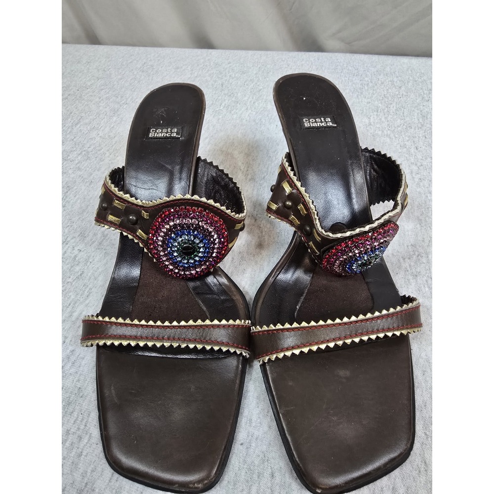Costa Blanca Jennie slide heels feature a brown leather design adorned 9.5